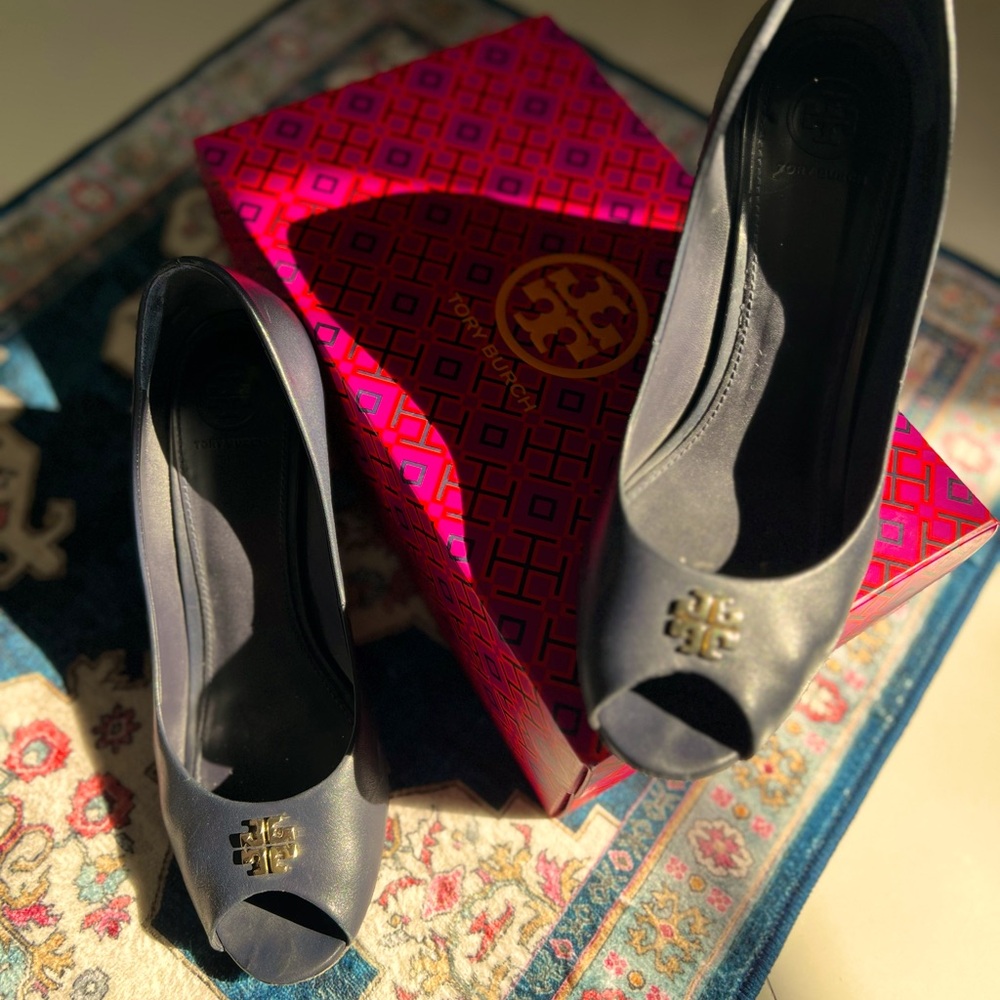 Tory Burch navy blue leather wedge shoes with gold accent.